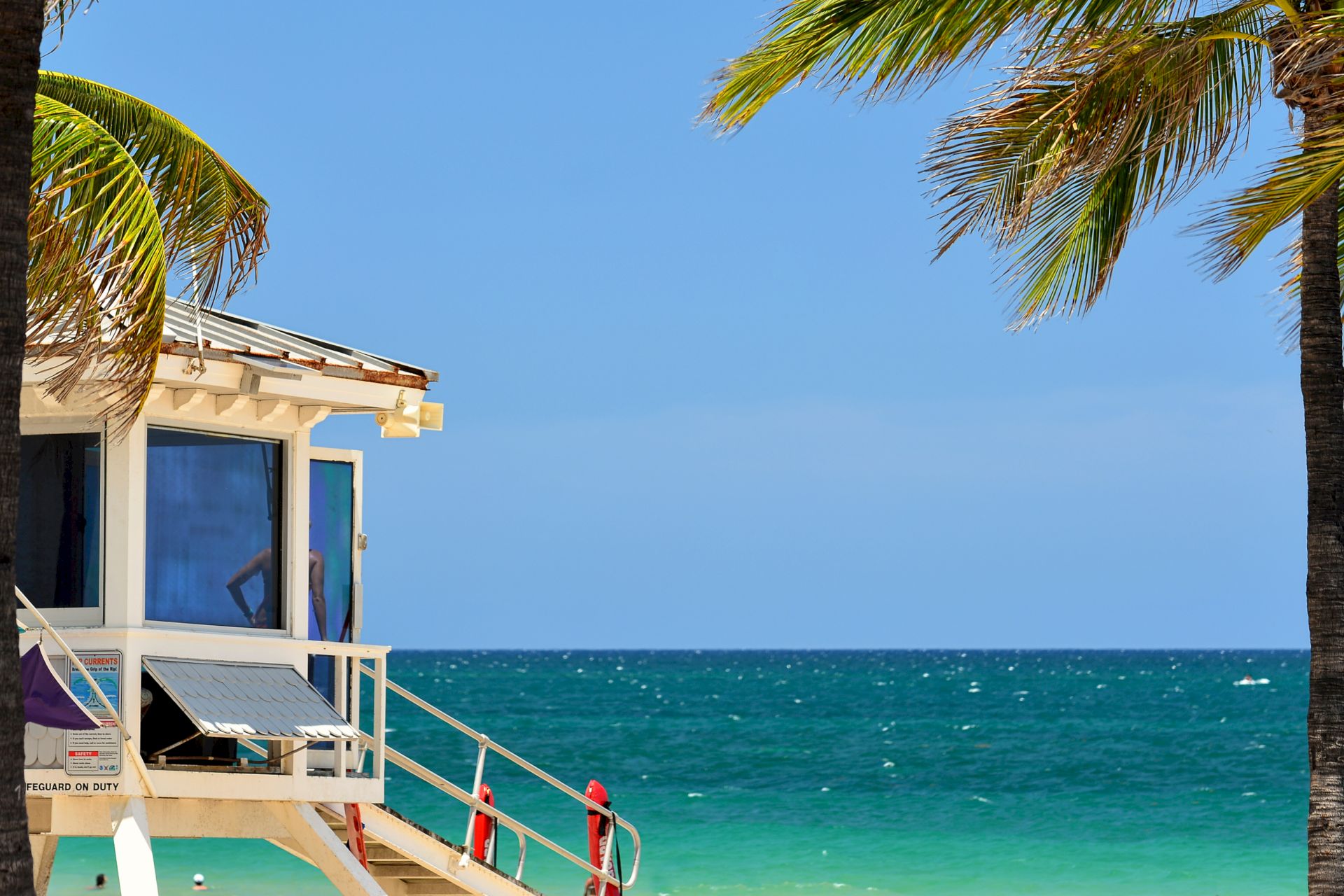 A lifeguard station on a beach with palm trees